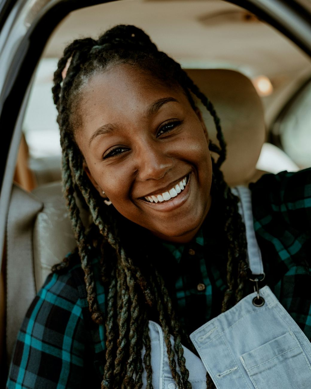 Woman smiling inside her car