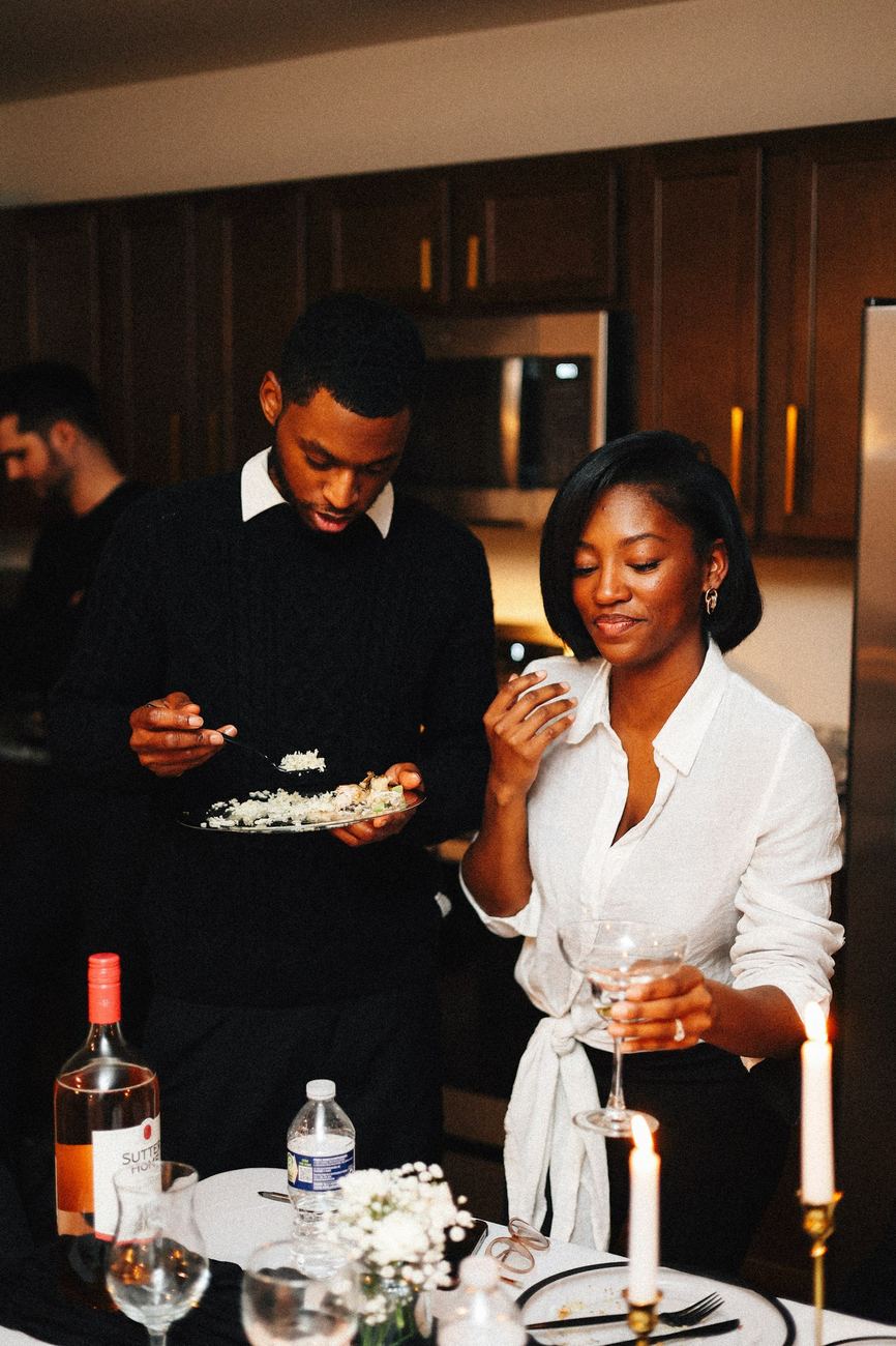 Friends laughing together over dinner at home